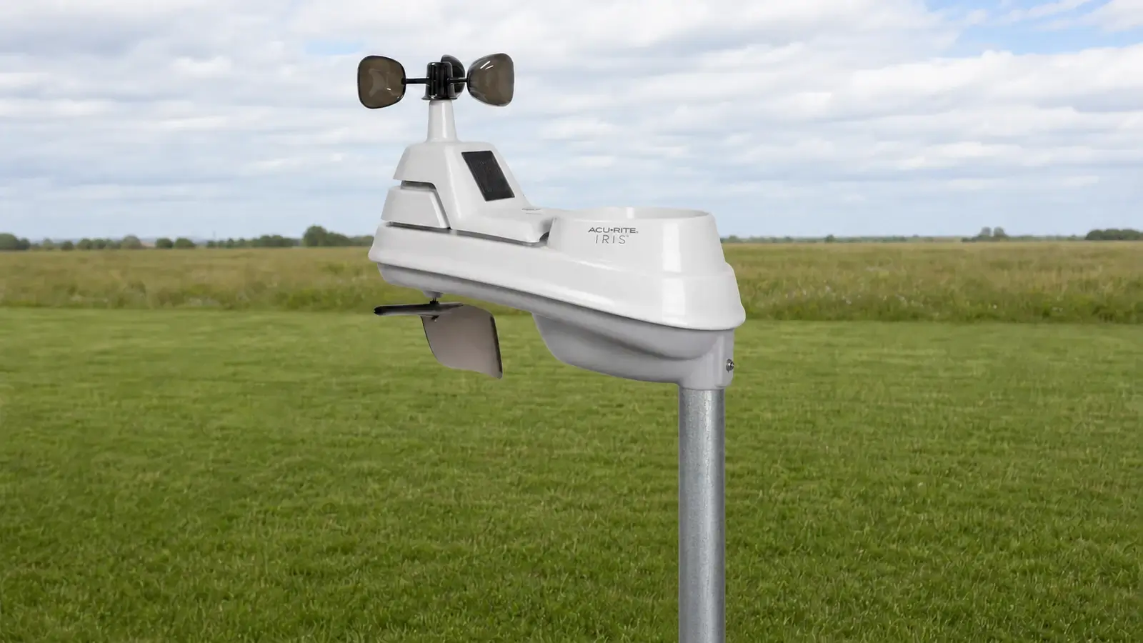 AcuRite 06004MA1 Iris sensor mounted directly on three-quarter-inch steel pipe in an open grassy site